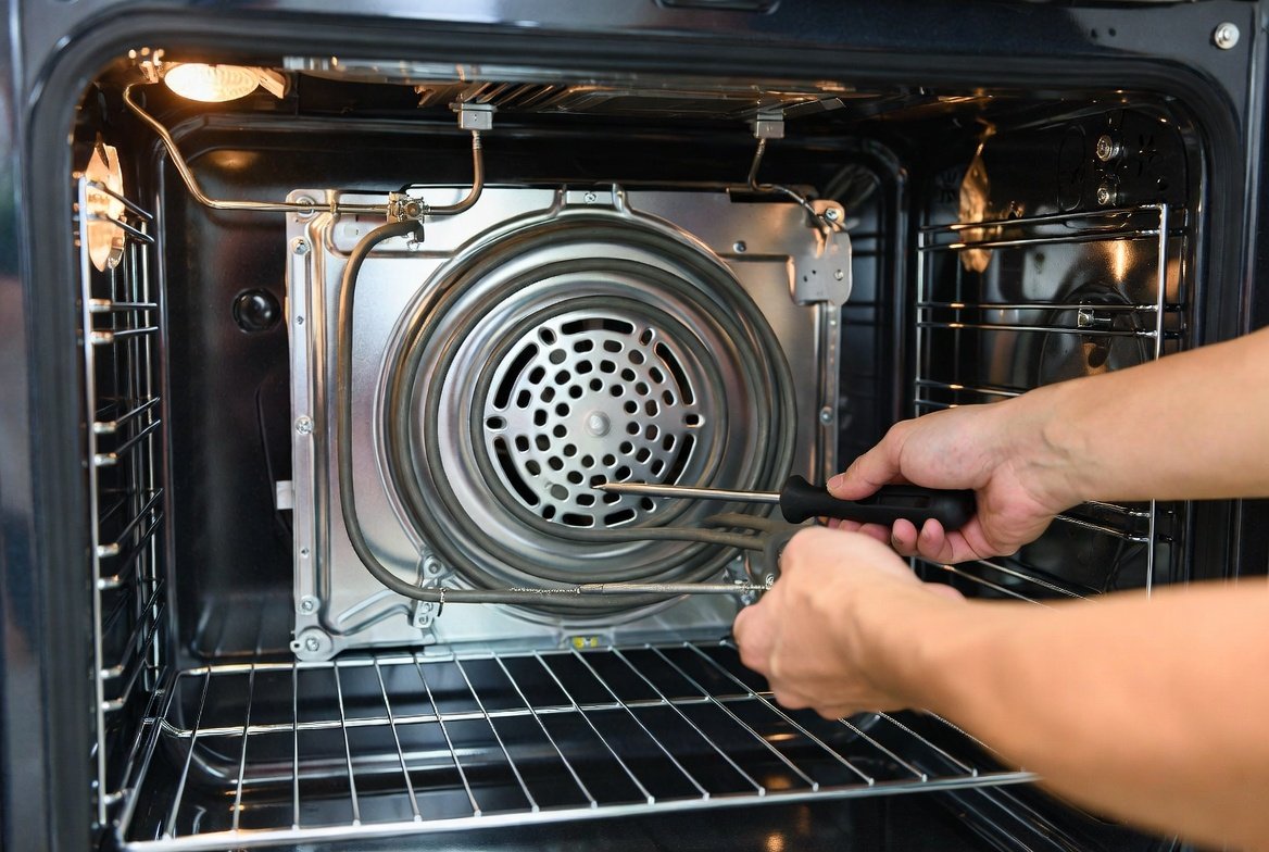 Oven heating element being replaced